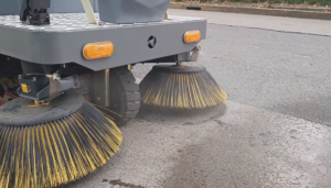 Ride-on sweeper in a warehouse
