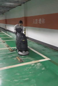 Automated floor scrubber in large warehouse